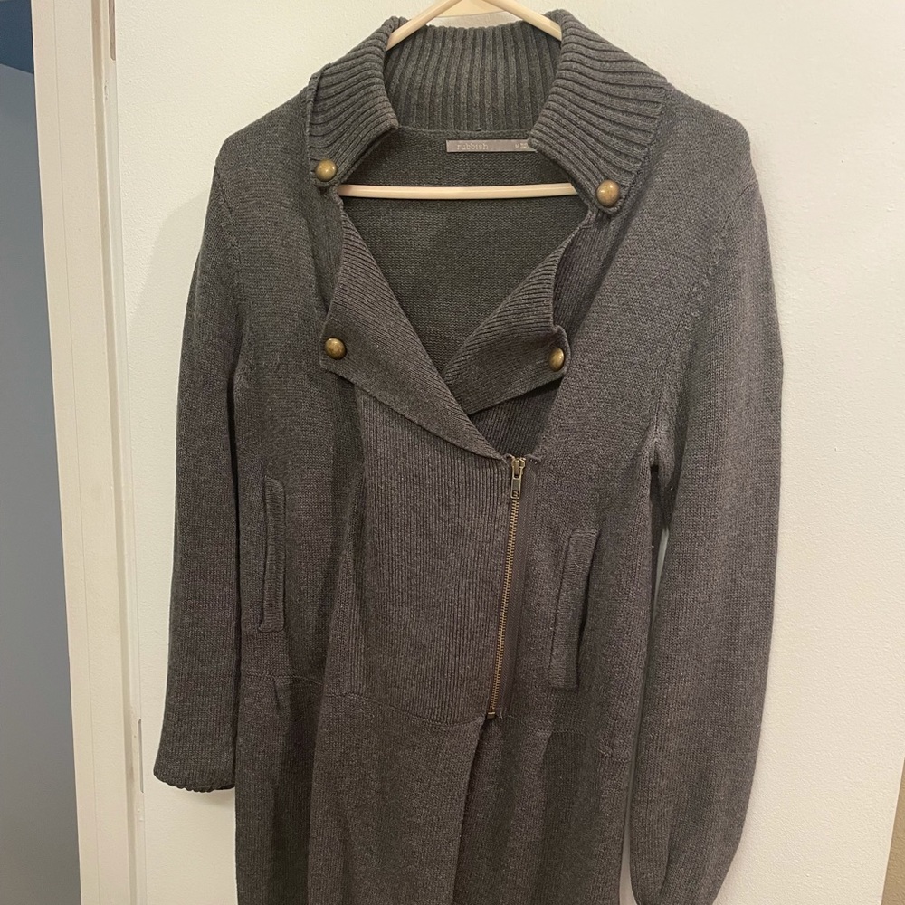 Grey sweater with brass accents